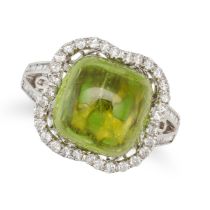 A PERIDOT AND DIAMOND RING set with a cabochon peridot in a border of round cut diamonds, the bif...