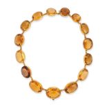 AN ANTIQUE CITRINE RIVIERE NECKLACE in yellow gold, comprising a row of oval cut citrines, no ass...