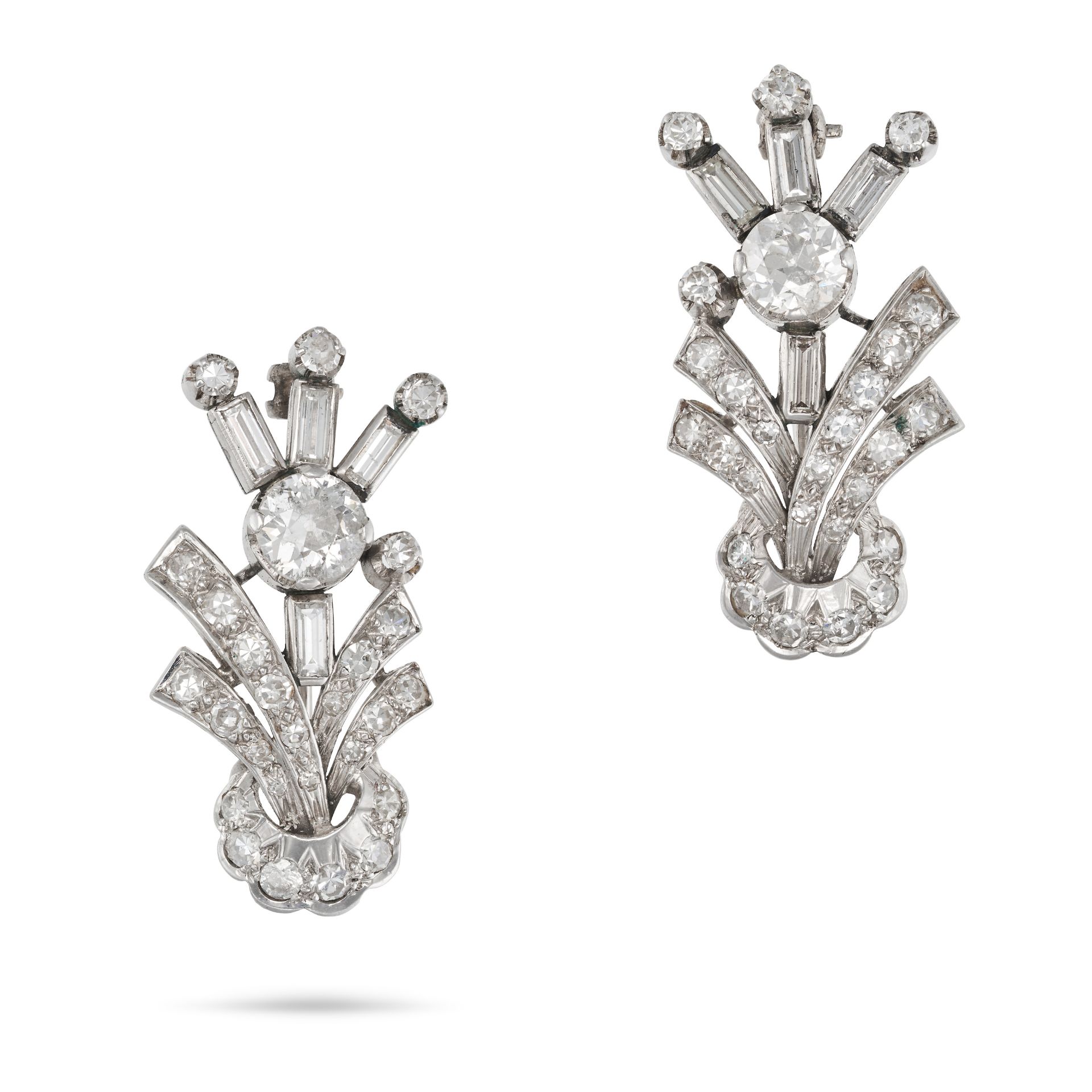 A PAIR OF DIAMOND FLOWER BROOCHES each designed as a stylised flower, set with an old cut diamond...