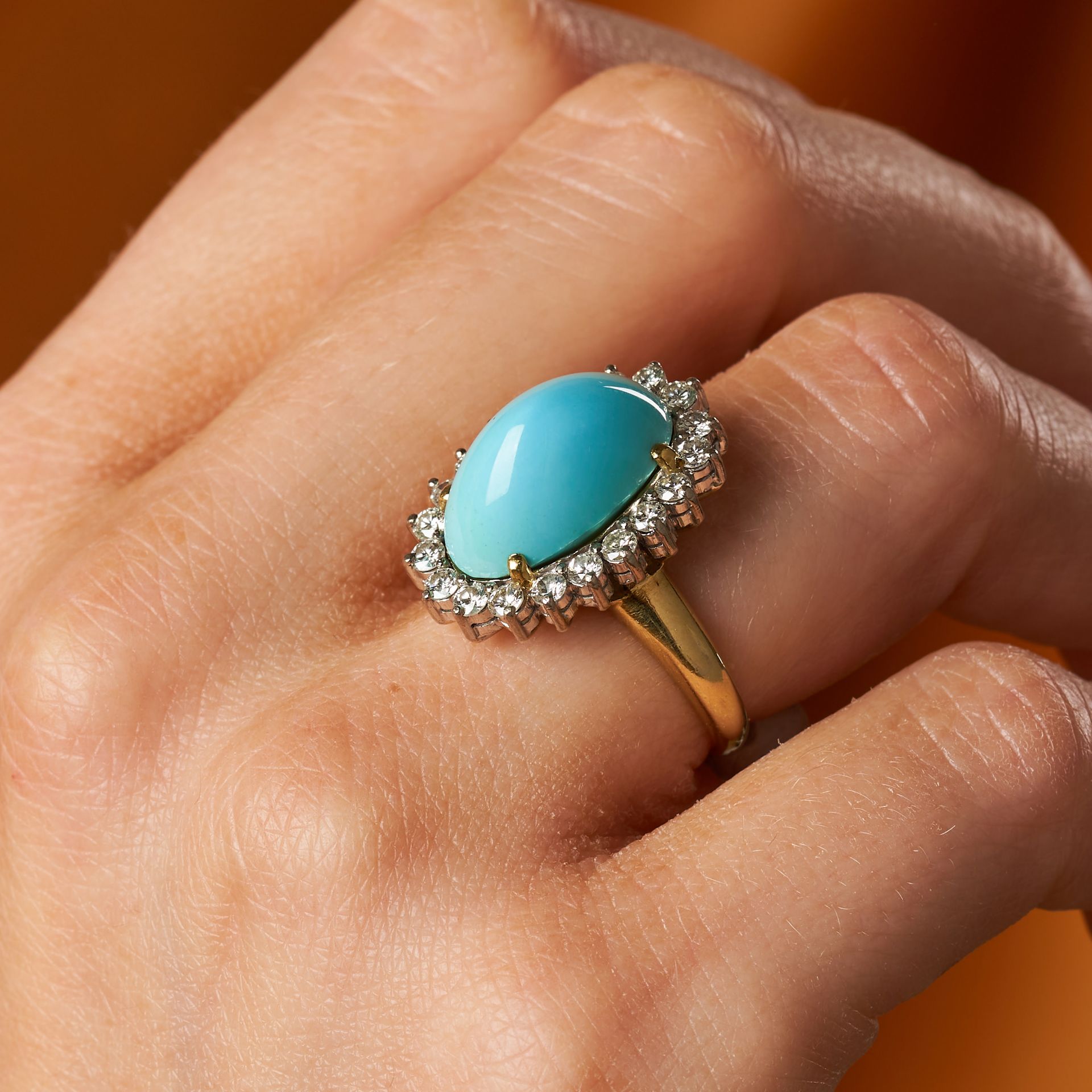 A TURQUOISE AND DIAMOND CLUSTER RING set with an oval cabochon turquoise in a cluster of round br... - Image 2 of 2