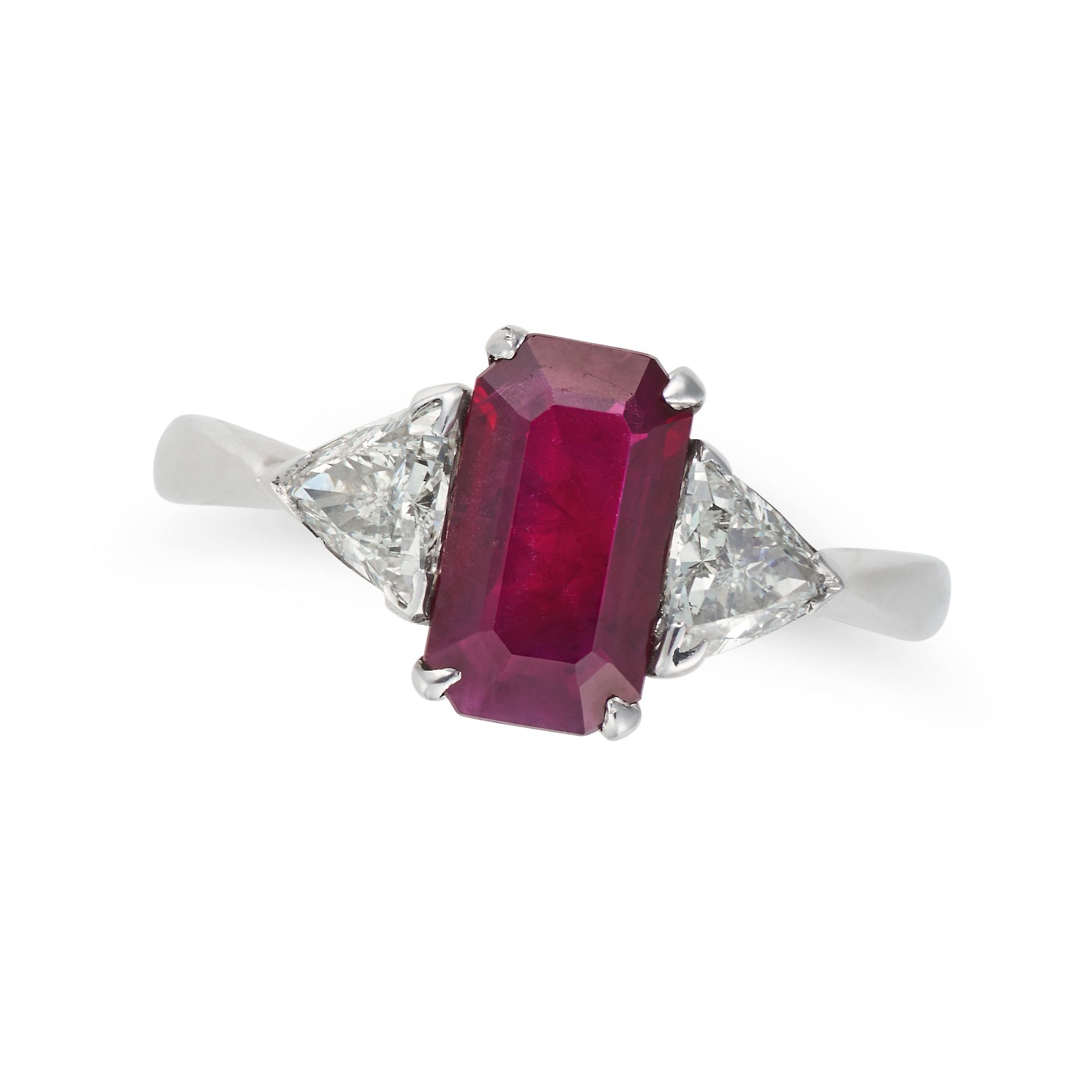 A BURMESE RUBY AND DIAMOND THREE STONE RING in 18ct white gold, set with an octagonal step cut ru...