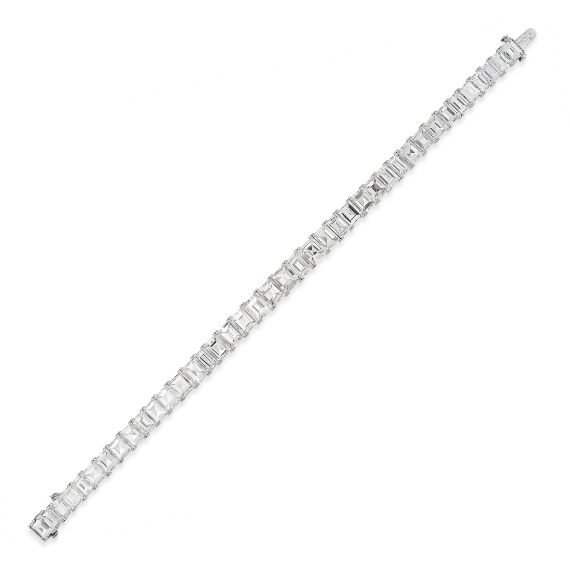 A FINE DIAMOND LINE BRACELET comprising a row of rectangular step cut diamonds, the diamonds all ... - Image 2 of 2
