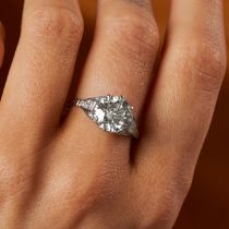 A 3.25 CARAT SOLITAIRE DIAMOND RING set with a round brilliant cut diamond of 3.25 carats, the sh...