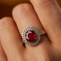 A 2.52 CARAT BURMA NO HEAT RUBY AND DIAMOND RING in 18ct white gold, set with an oval cut ruby of...