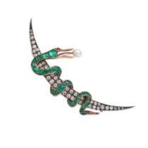 AN ANTIQUE EMERALD, DIAMOND, PEARL AND RUBY CRESCENT MOON AND SNAKE BROOCH in yellow gold and sil...