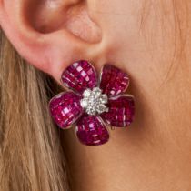 A PAIR OF RUBY AND DIAMOND FLOWER EARRINGS each designed as a flower set with a cluster of round ...