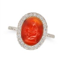 A CARNELIAN AND DIAMOND INTAGLIO RING set with an oval carnelian intaglio carved to depict a clas...