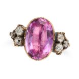 A PINK TOPAZ AND DIAMOND RING set with an oval cut pink topaz of approximately 9.78 carats, the s...