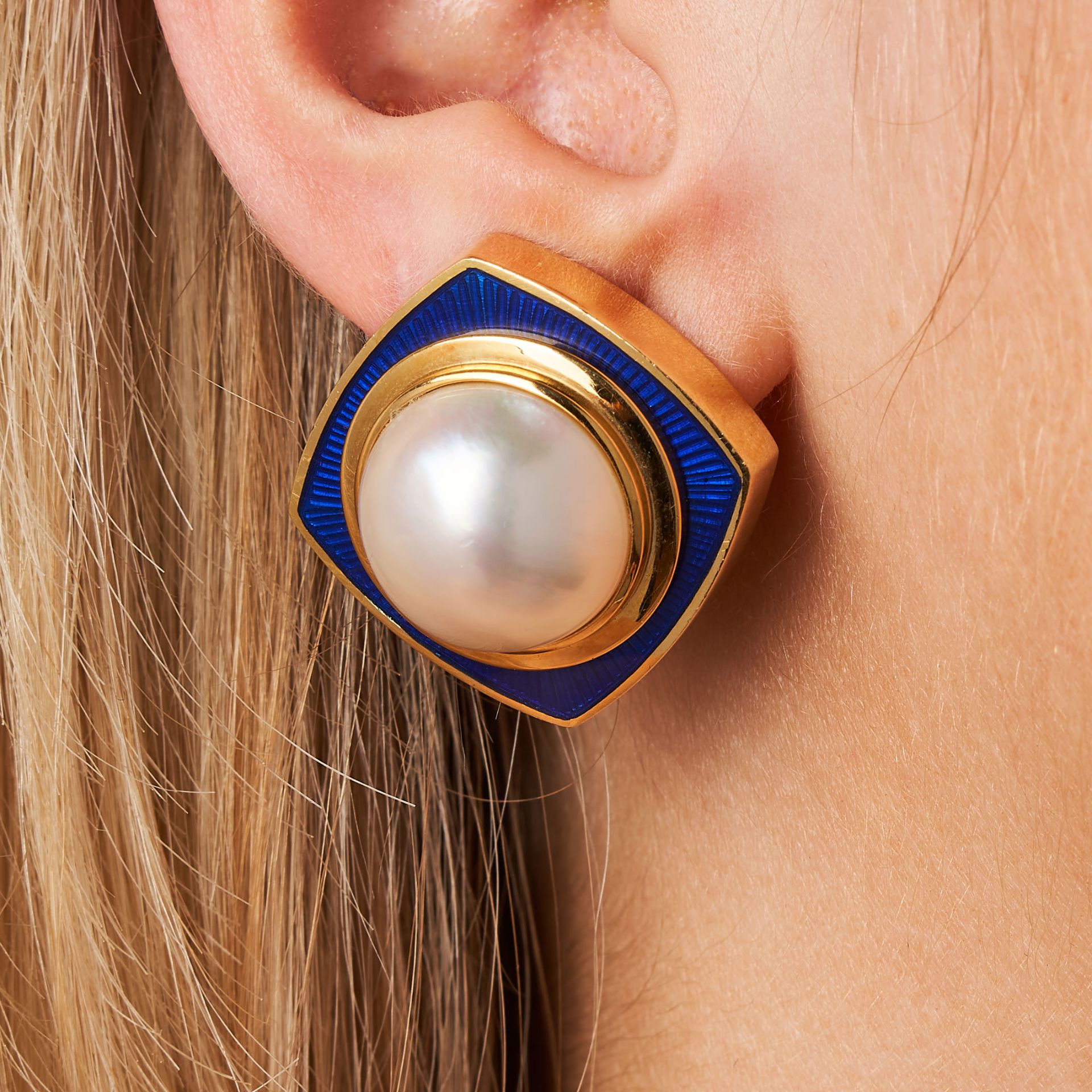 TIFFANY & CO., A PAIR OF VINTAGE MABE PEARL AND ENAMEL CLIP EARRINGS in 18ct yellow gold, each se...