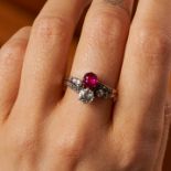 AN ANTIQUE AUSTRIAN BURMA NO HEAT RUBY AND DIAMOND RING in yellow gold, set with a cushion cut ru...