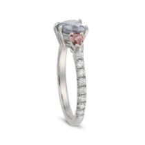 A BLUE AND PINK DIAMOND RING set with a heart cut blue diamond of approximately 0.97 carats betwe...