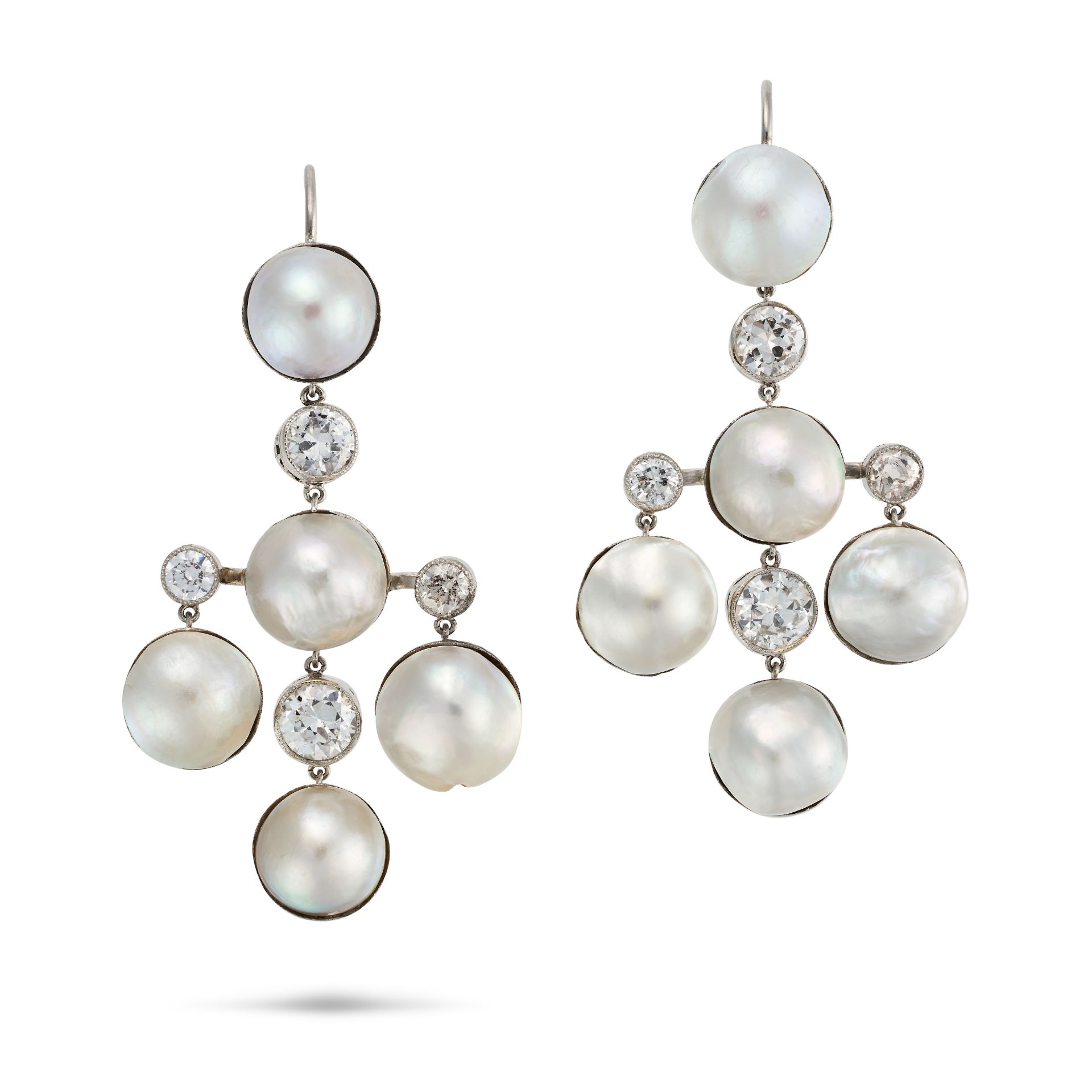 A PAIR OF NATURAL SALTWATER PEARL AND DIAMOND DROP EARRINGS each comprising a row of alternating ...