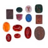 A COLLECTION OF UNMOUNTED AGATE, GLASS, SARDONYX AND BLOODSTONE INTAGLIOS comprising thirteen int...