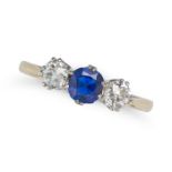 A SAPPHIRE AND DIAMOND THREE STONE RING set with a cushion cut sapphire accented on each side by ...
