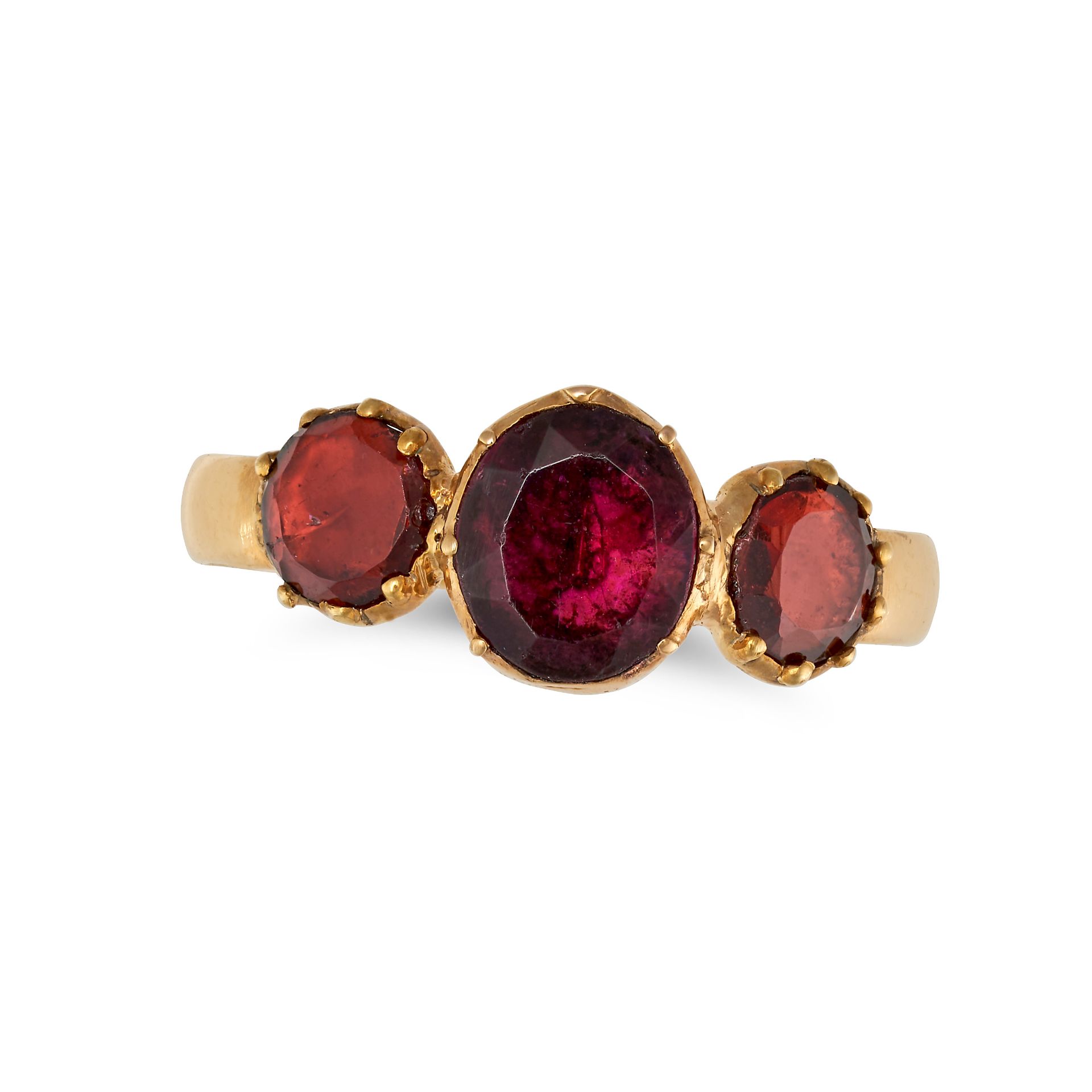 AN ANTIQUE THREE STONE GARNET RING in 18ct yellow gold, set with an oval cut garnet between two r...