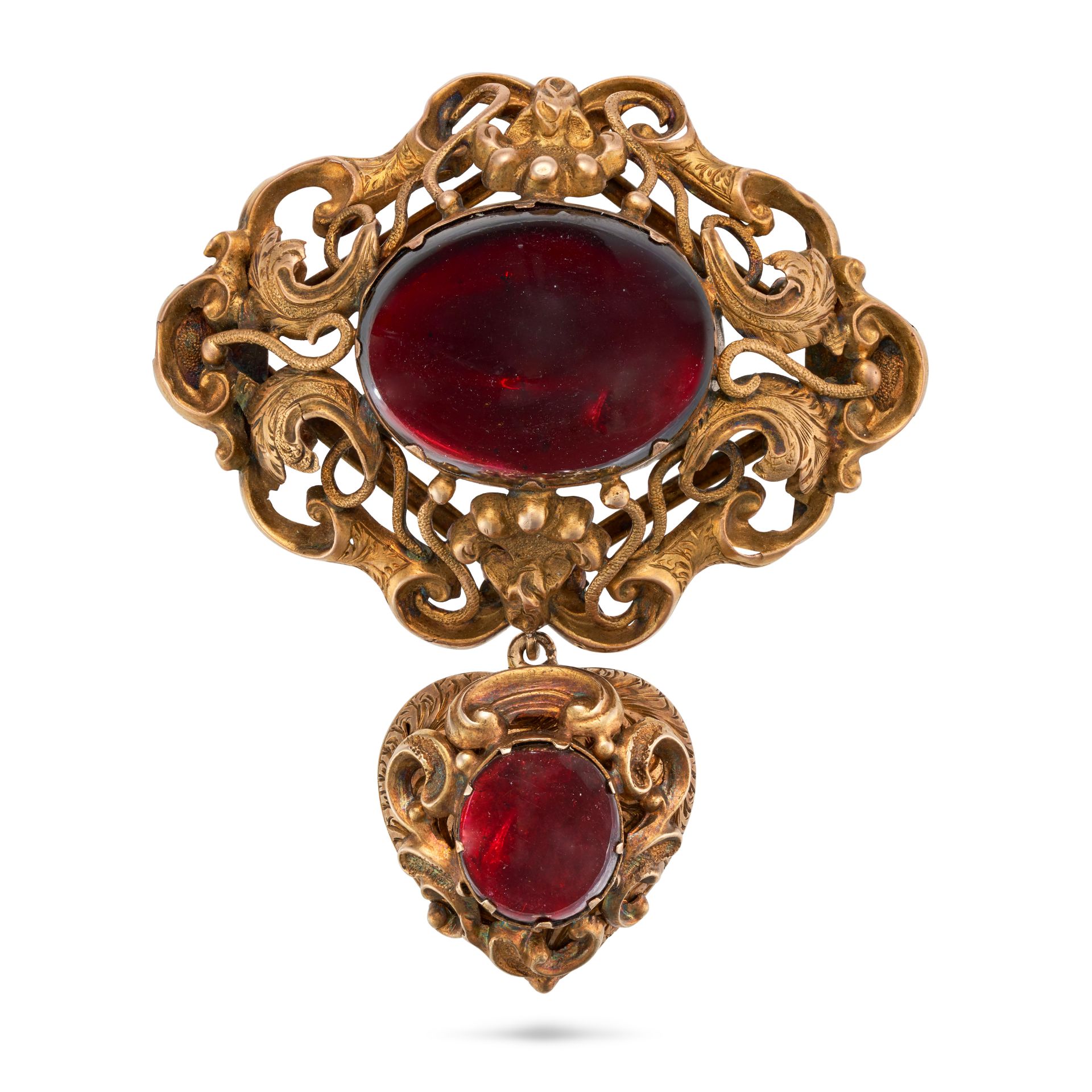 AN ANTIQUE GARNET LOCKET BROOCH in yellow gold, the scrolling foliate brooch set with a large cab...