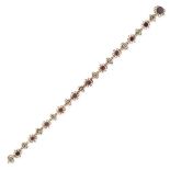 AN ANTIQUE GARNET AND PASTE BRACELET comprising a row of alternating oval cut garnets and old cut...