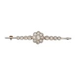AN ANTIQUE DIAMOND BAR BROOCH in yellow gold, set with a cluster of old cut diamonds accented by ...