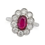 A RUBY AND DIAMOND CLUSTER RING in 18ct white gold, set with a cushion cut ruby of approximately ...