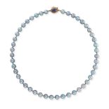 NO RESERVE - A GREY PEARL NECKLACE comprising a row of pearls, the clasp set with a cabochon lapi...