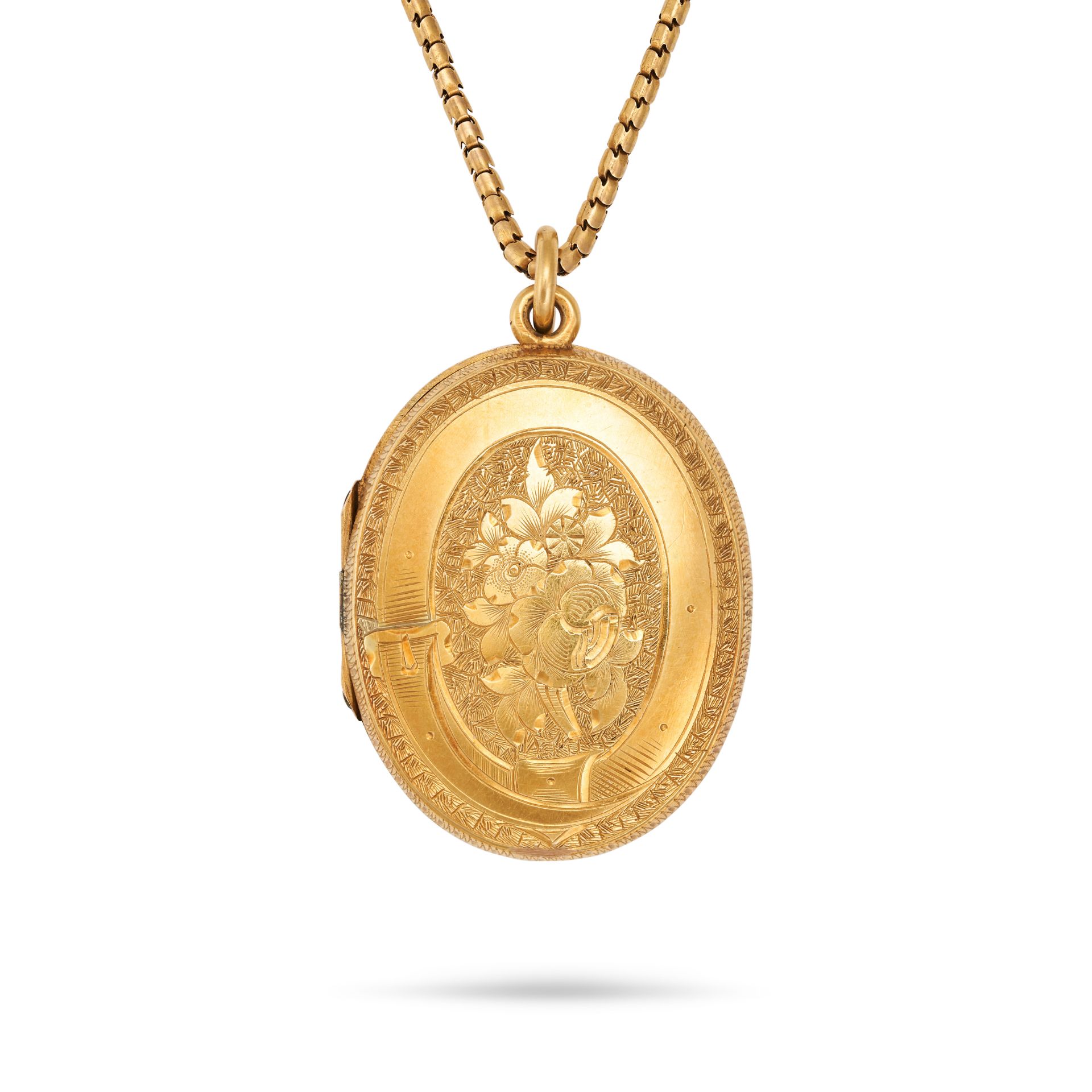 AN ANTIQUE LOCKET PENDANT NECKLACE the oval hinged locket designed as a belt engraved with foliat...