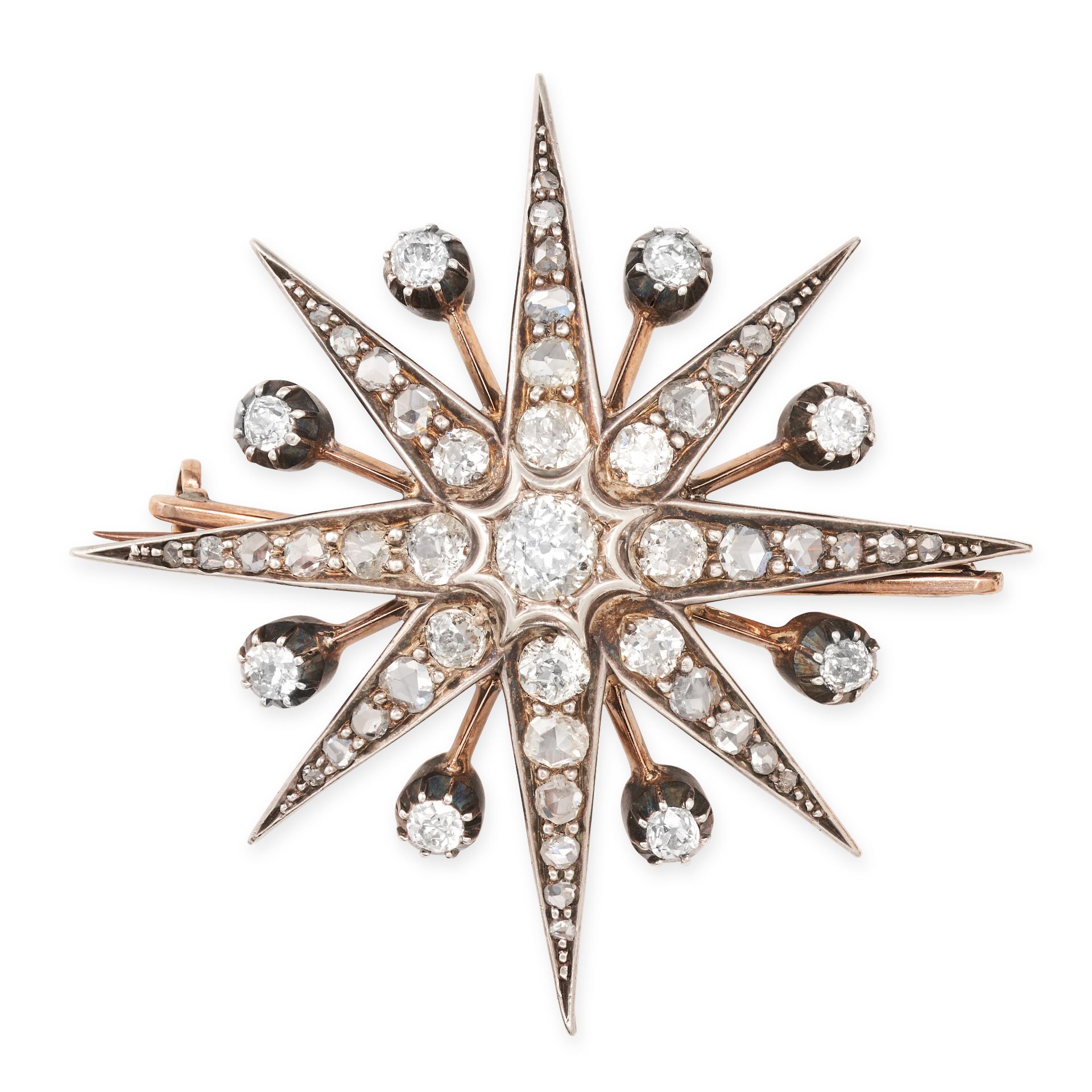 AN ANTIQUE DIAMOND STAR BROOCH / PENDANT in yellow gold and silver, designed as an eight rayed st...