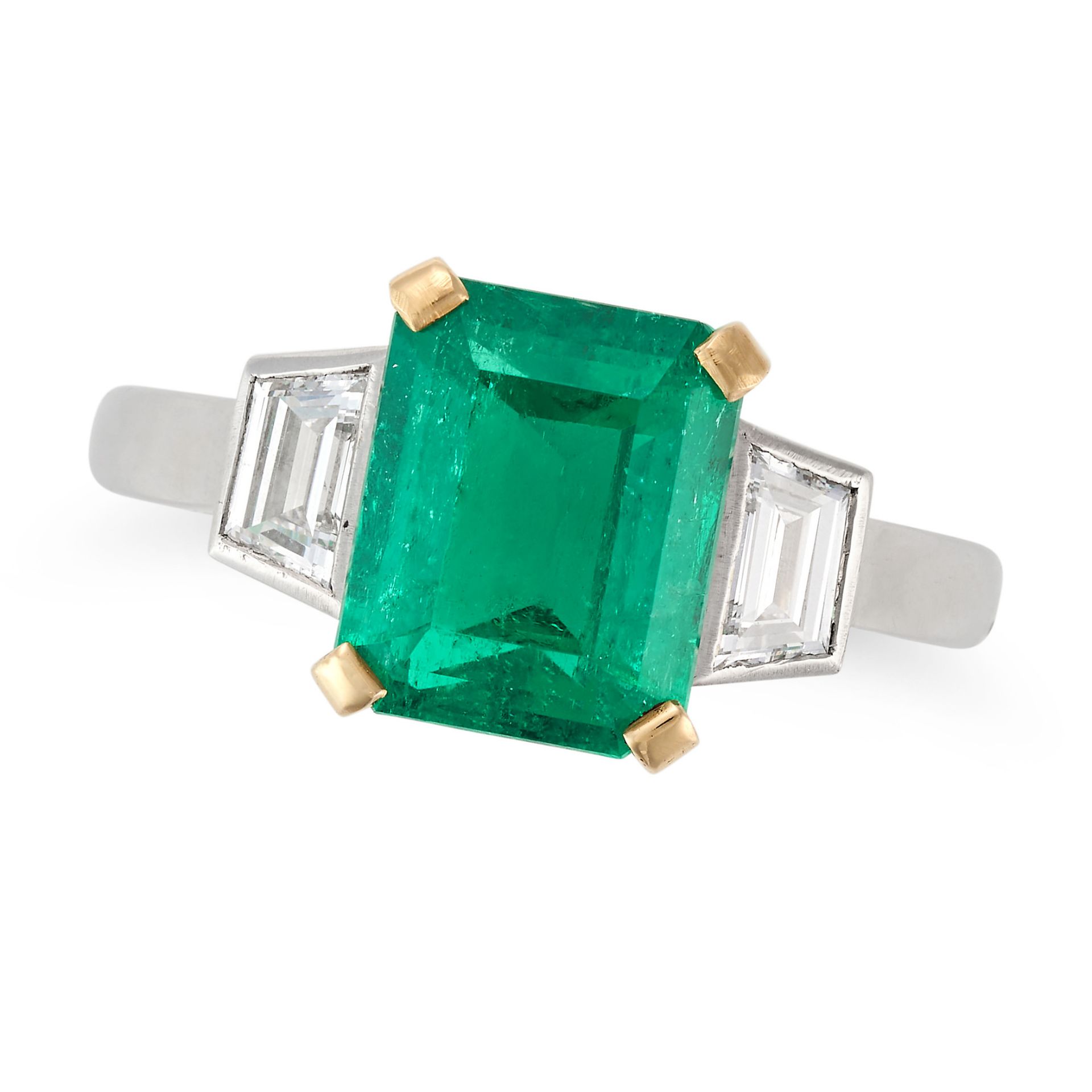 A COLOMBIAN EMERALD AND DIAMOND THREE STONE RING set with an octagonal step cut emerald of 3.05 c...