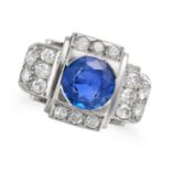 A RETRO SAPPHIRE AND DIAMOND RING in platinum, set with a round cut sapphire accented by single a...