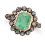 AN ANTIQUE EMERALD AND DIAMOND RING in 18ct yellow gold and silver, set with an octagonal step cu...