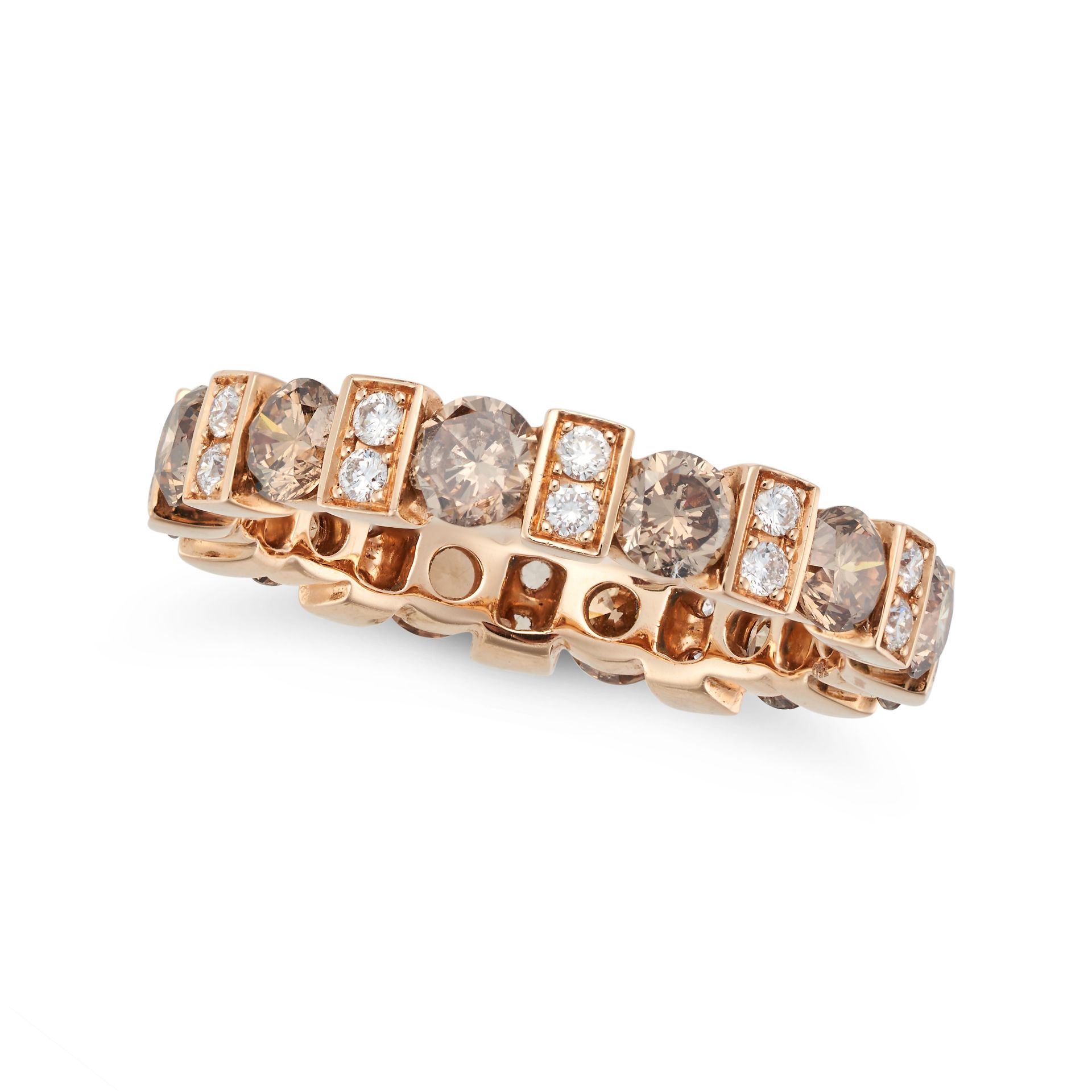 A COGNAC DIAMOND ETERNITY RING set all around with alternating round brilliant cut cognac diamond...