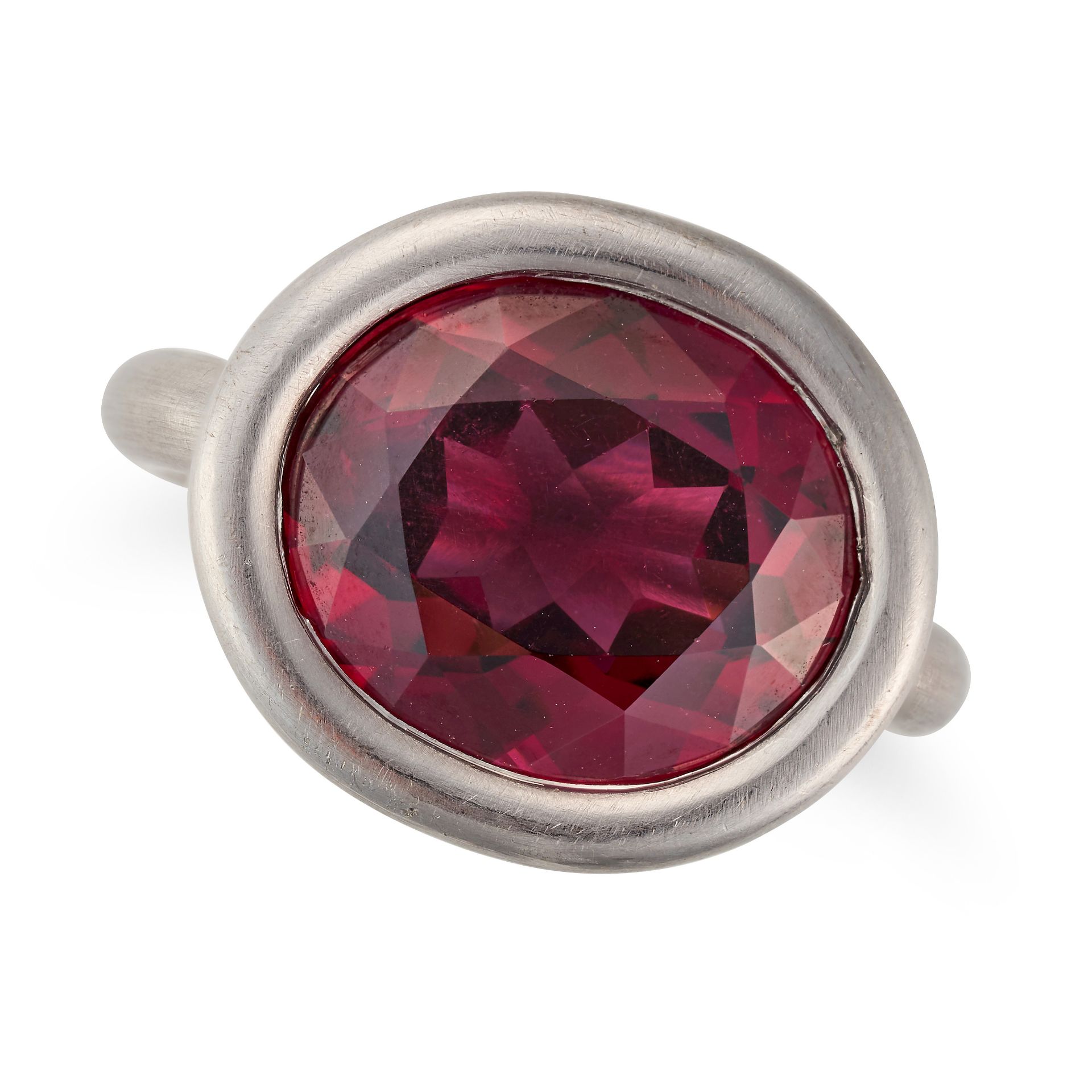 A RHODALITE GARNET RING set east to west with an oval cut rhodalite garnet, marked indistinctly, ...