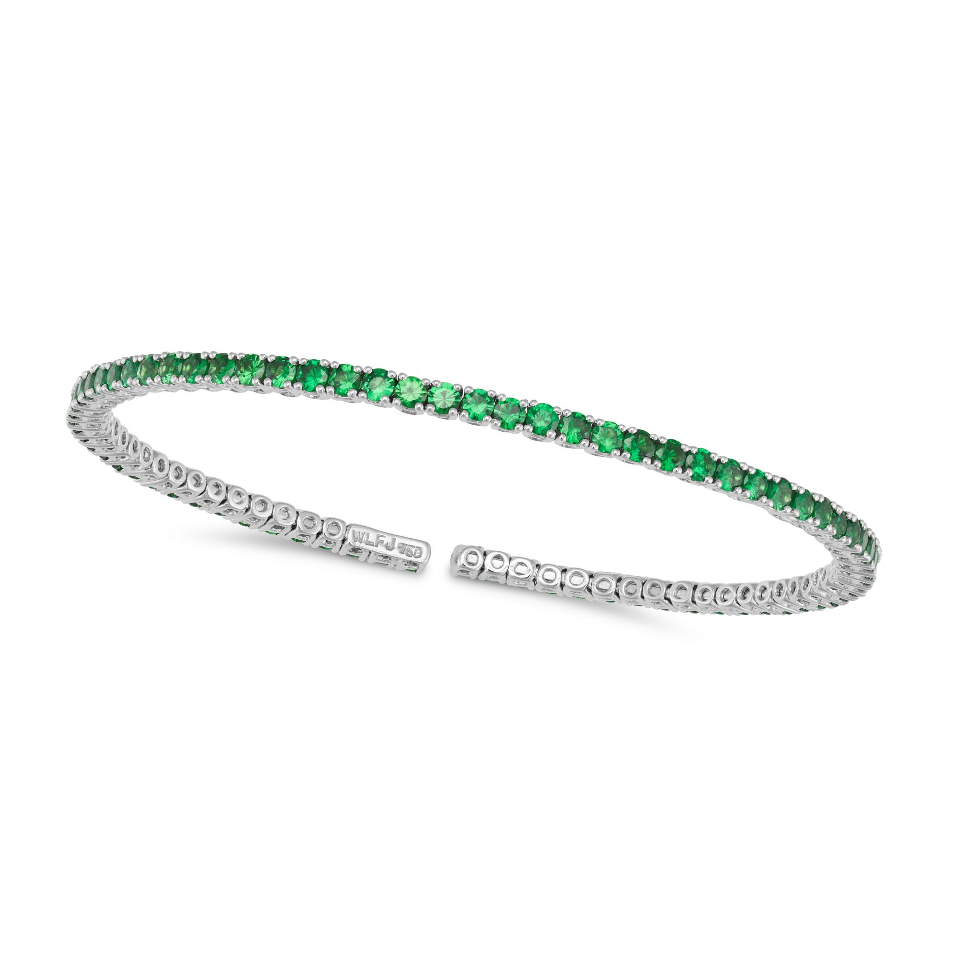 A TSAVORITE GARNET BANGLE in 18ct white gold, the open bracelet set with a row of round cut tsavo...