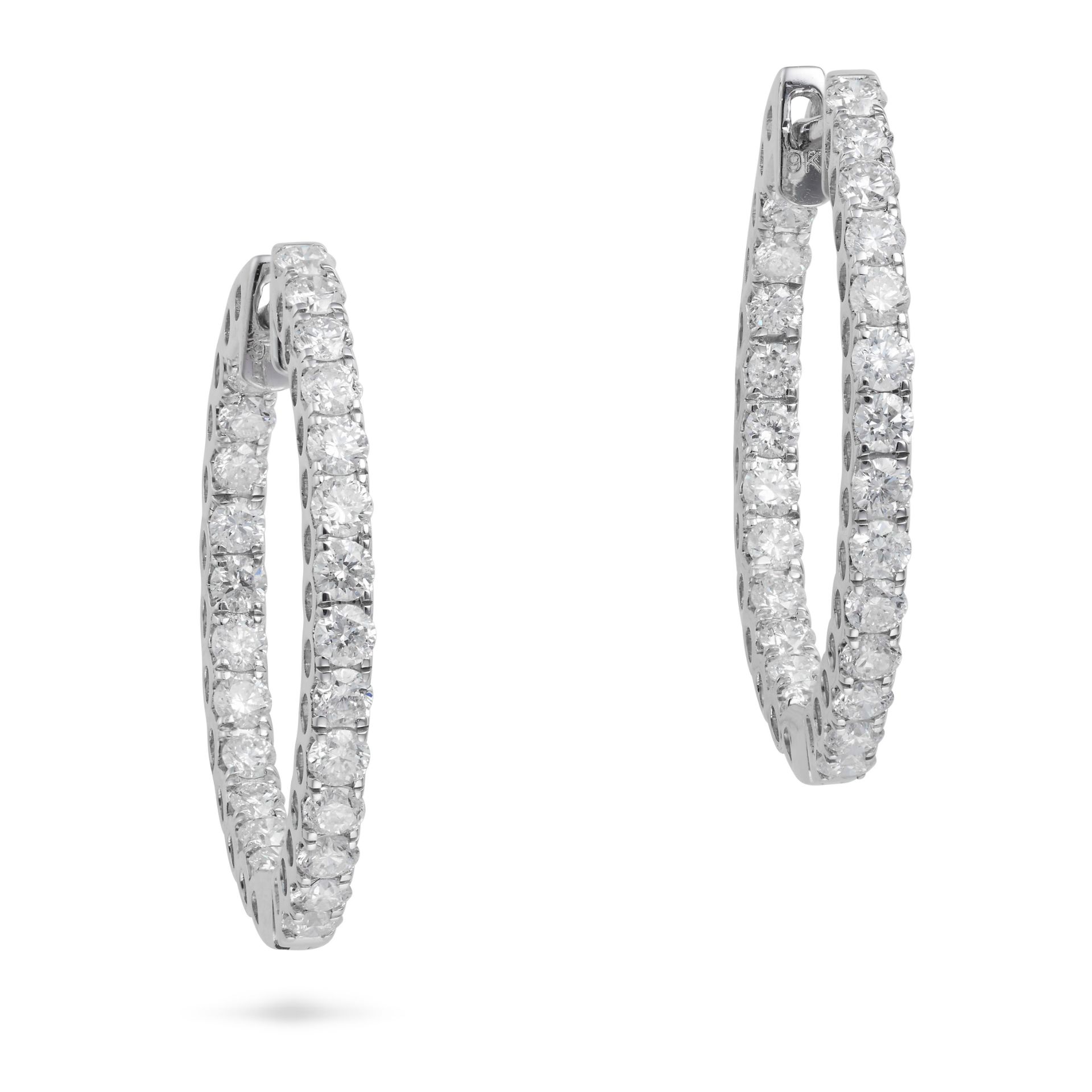 A PAIR OF DIAMOND HOOP EARRINGS each designed as a hoop set with a row of round brilliant cut dia...