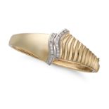 A DIAMOND BANGLE the hinged bangle in fluted design, accented by two rows of round brilliant cut ...