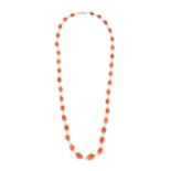A CARNELIAN AND PEARL NECKLACE comprising a row of polished carnelian beads and pairs of pearls, ...