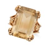 A VINTAGE CITRINE RING in yellow gold, set with an octagonal step cut citrine in an ornate settin...