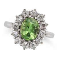 A TSAVORITE GARNET AND DIAMOND CLUSTER RING in 18ct white gold, set with an oval cut tsavorite ga...