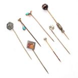NO RESERVE - A GROUP OF STICK / TIE PINS comprising a banded agate pin, a white paste stone pin, ...