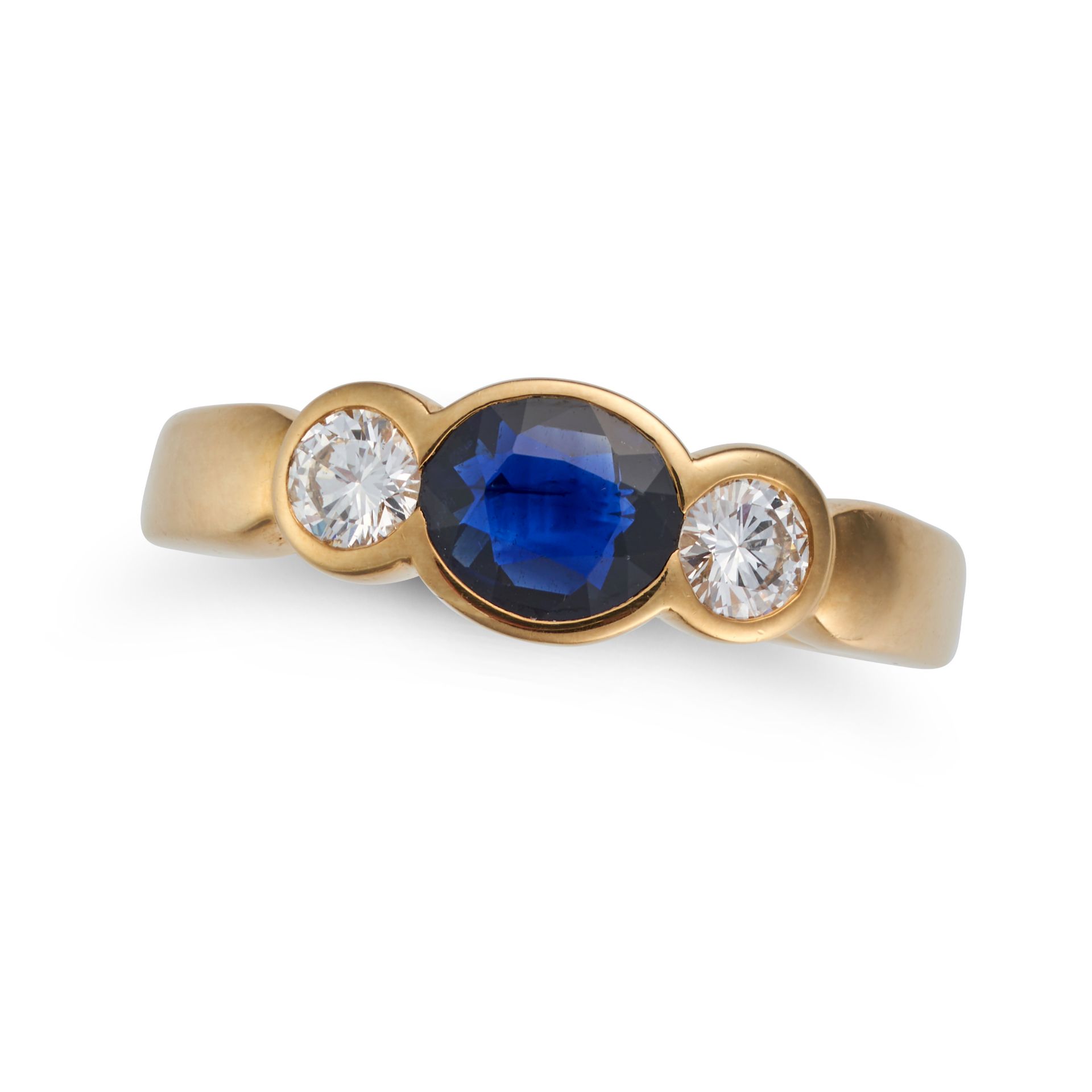 A SAPPHIRE AND DIAMOND THREE STONE RING set with an oval cut sapphire accented on each side by a ...