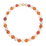 A PEARL AND AMBER NECKLACE comprising a single row of alternating pearls and amber beads, stamped...