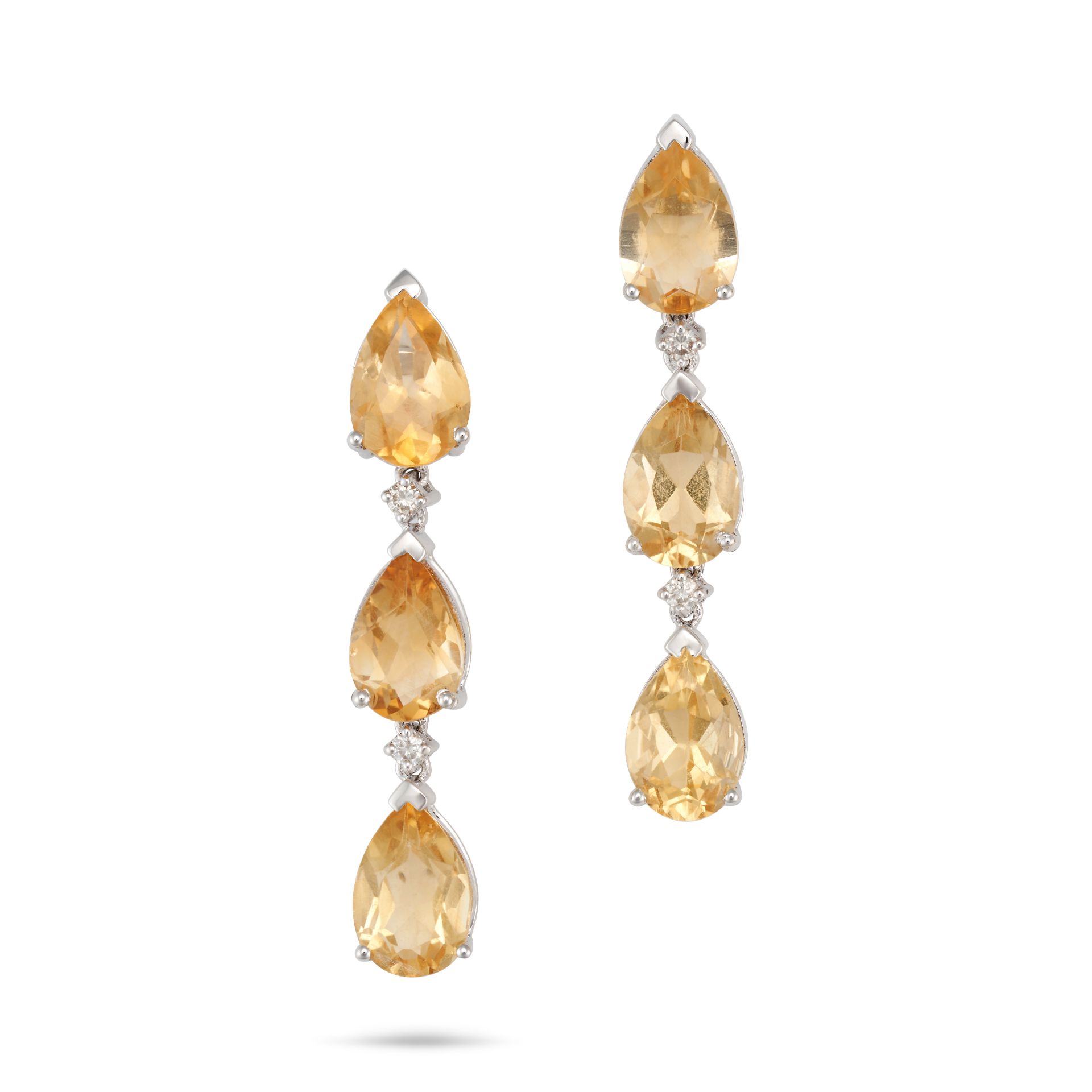 A PAIR OF YELLOW TOPAZ AND DIAMOND EARRINGS each set with a row of pear cut yellow topaz, accente...
