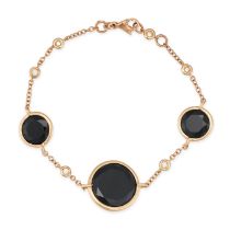 AN ONYX AND DIAMOND BRACELET comprising three round cut onyx accented by round brilliant cut diam...