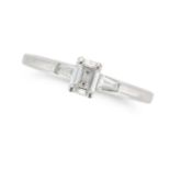NO RESERVE - A SOLITAIRE DIAMOND RING in platinum, set with an emerald cut diamond between two ta...