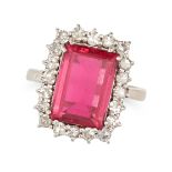 A PINK TOURMALINE AND DIAMOND CLUSTER RING set with an octagonal step cut pink tourmaline in a cl...