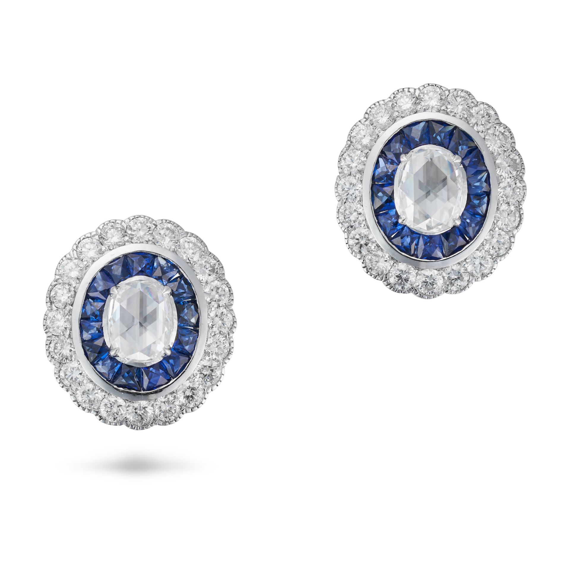 A PAIR OF DIAMOND AND SAPPHIRE TARGET EARRINGS each set with a rose cut diamond in a border of ca...