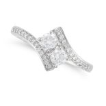 A DIAMOND CROSSOVER RING in platinum, set with two round brilliant cut diamonds accented by round...