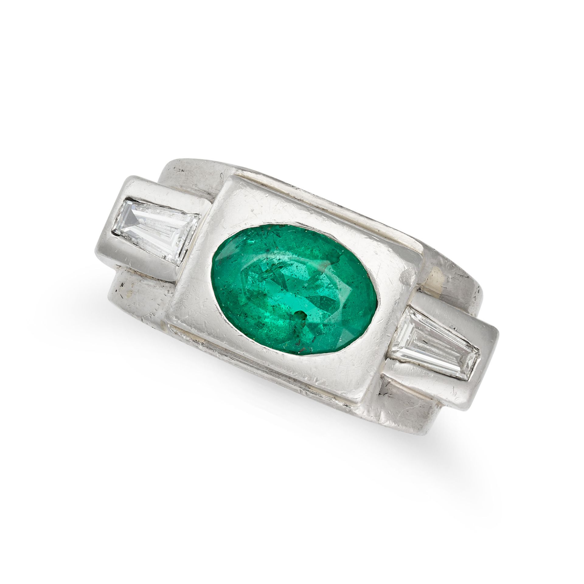 AN EMERALD AND DIAMOND TANK RING set with an oval cut emerald accented on each side by a tapered ...
