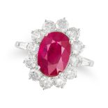 A RUBY AND DIAMOND CLUSTER RING set with an oval cut ruby of approximately 2.45 carats in a clust...