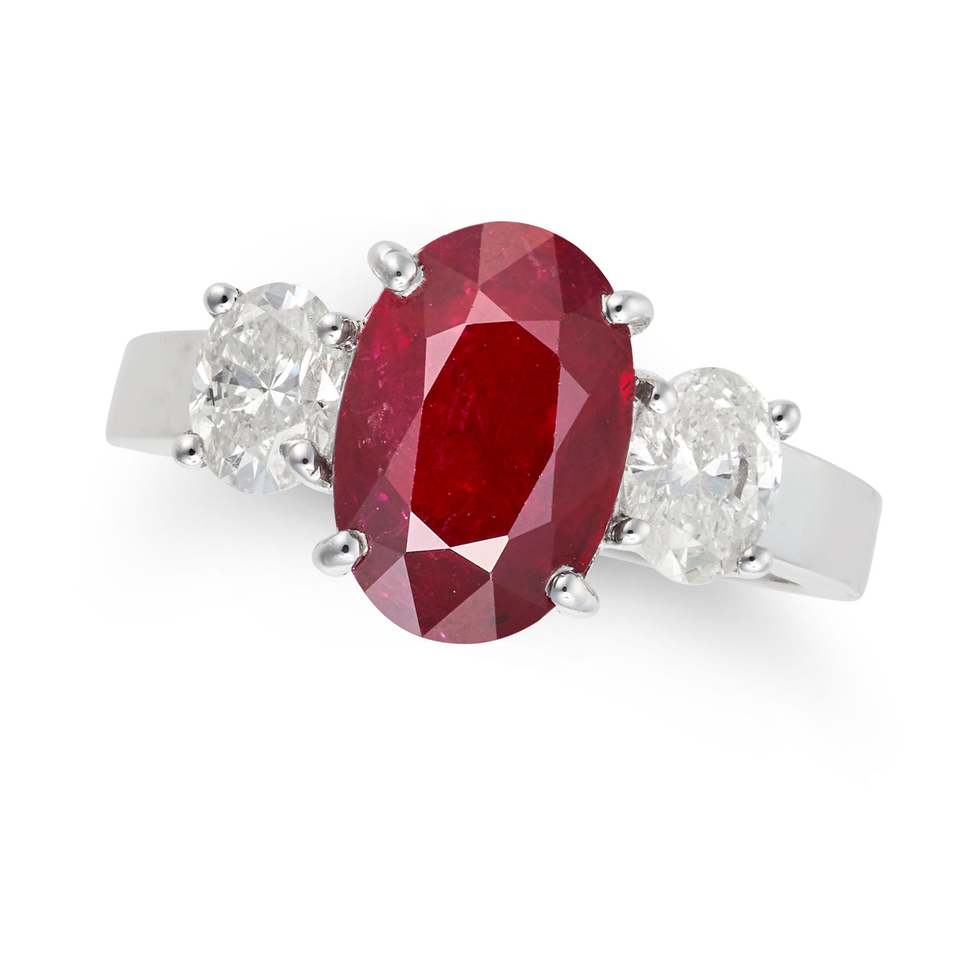 A RUBY AND DIAMOND THREE STONE RING set with an oval cut ruby of 2.74 carats, accented on each si...