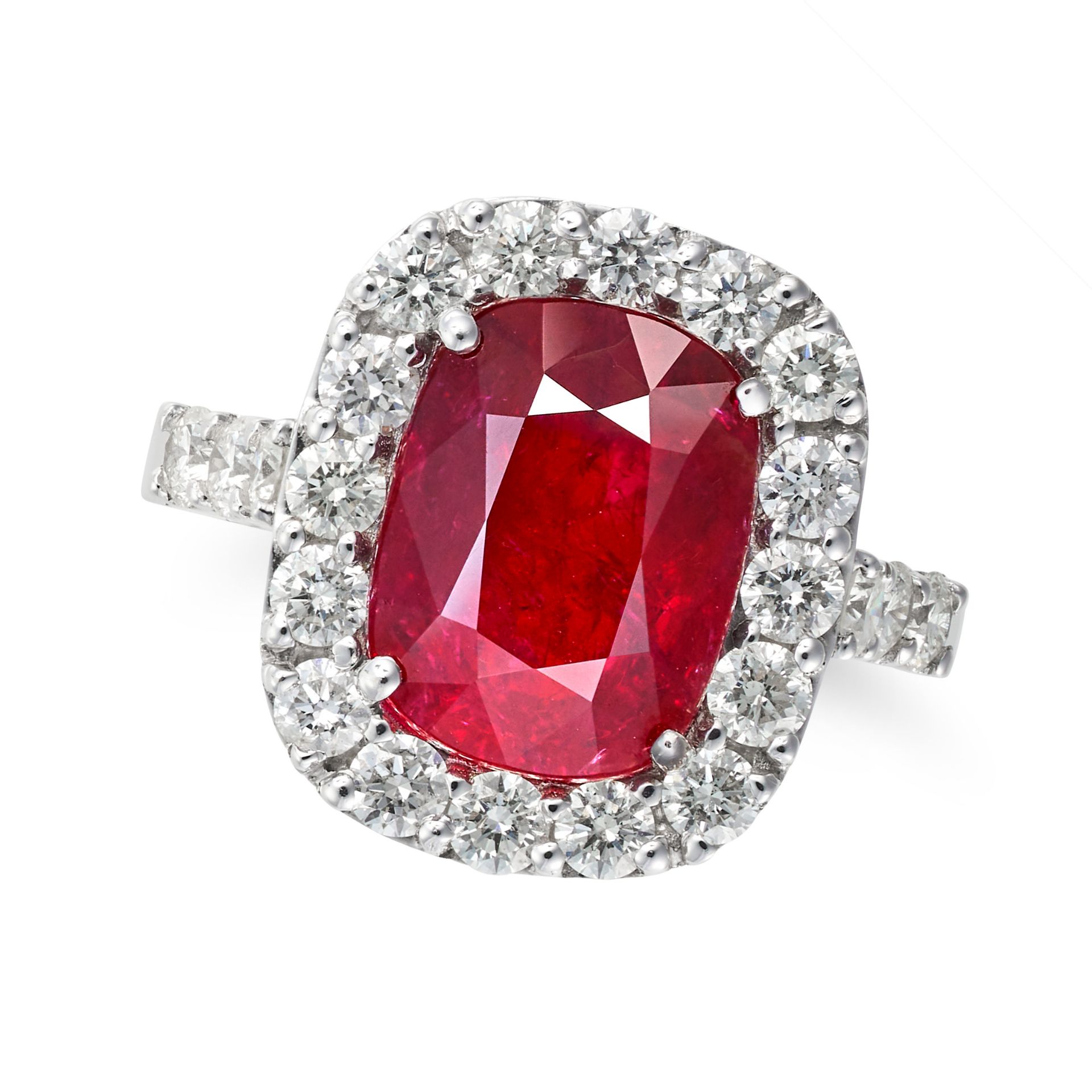 A RUBY AND DIAMOND CLUSTER RING set with a cushion cut ruby of 5.02 carats in a cluster of round ...